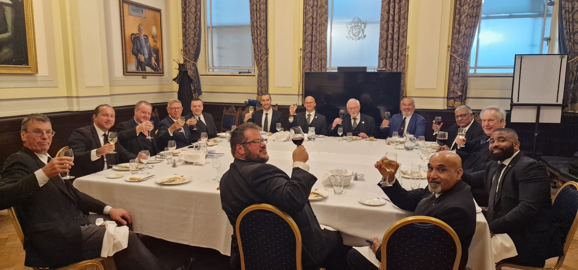 Members sharing a toast at the Festive Board